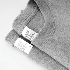 Primer plano del cuello de camiseta gris con etiqueta de talla L y detalles de costura