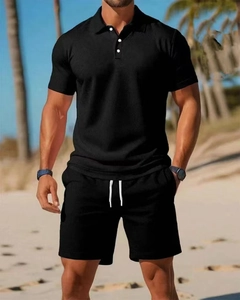 Close-up of men's black polo shirt set with waffle texture and drawstring shorts detail
