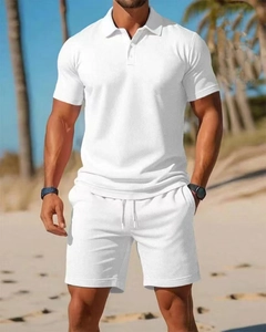 Close-up of white waffle knit texture on men's polo shirt and drawstring shorts set