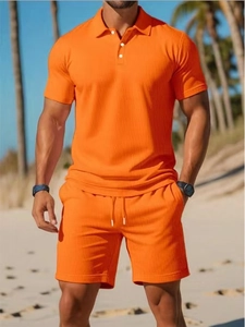 Detail view of the orange waffle texture fabric on this summer men's polo and shorts set