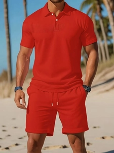 Close-up of bright red men's summer polo set with white drawstrings on a beach scene