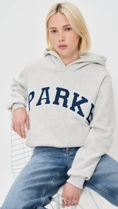 Detail of grey oversized hoodie featuring blue PARKER collegiate print and drop shoulder design