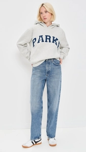 Full body view of women's grey hoodie with blue PARK print and blue straight jeans
