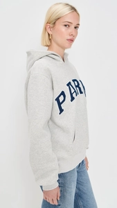 Detail view of heather grey hoodie featuring blue Paris lettering and kangaroo pocket