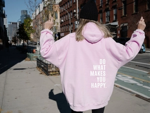 Pink oversized hoodie back view featuring white 'DO WHAT MAKES YOU HAPPY' text print