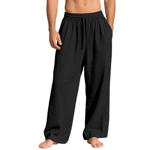 Detail view of black linen pants featuring drawstring elastic waistband and breathable texture