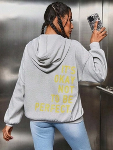 Detailansicht der Rückseite eines grauen Oversize-Hoodies mit gelbem Slogan-Aufdruck hinten