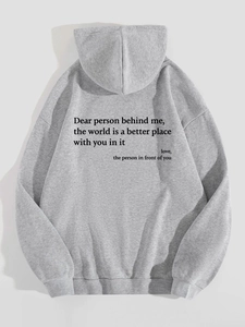 Detail view of the gray oversized hoodie showing the black letter print on the back