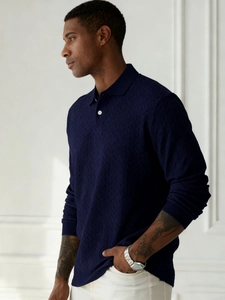 Close-up of navy knit long-sleeved polo shirt featuring premium textured herringbone pattern