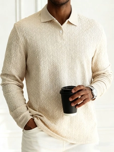 Macro shot of men's beige long sleeve polo shirt showing premium herringbone knit texture