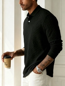 Detailed view of black knitted polo shirt texture featuring elegant herringbone patterns