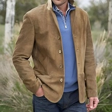 Detailed view of camel faux suede jacket styled with blue zip sweater and plaid shirt