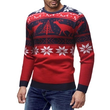 Detailed close-up of knitted reindeer and snowflake patterns on a festive Christmas sweater
