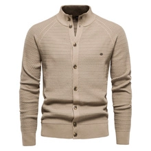 Detailed macro view of the knitted honeycomb texture and button closure on men's cardigan