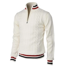 Detail of cable knit pattern and tri-color striped trim on men's half-zip sweater