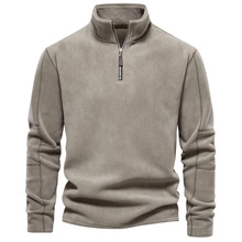 Detail of khaki fleece quarter-zip sweatshirt showing collar and metal zipper texture