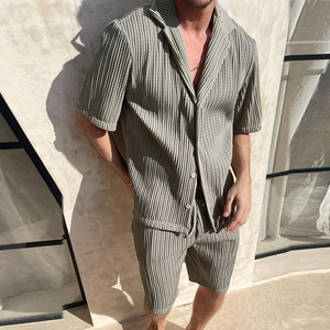 Detail of sage green plisse fabric texture on men's summer casual shirt and shorts set
