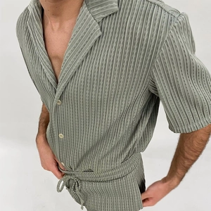 Detail of grey-green pleated shirt fabric and texture on stylish men's summer set