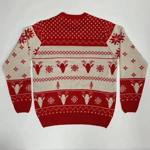 Close-up of Fair Isle knit sweater showing red and white reindeer and snowflake patterns