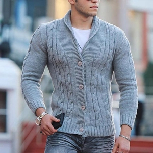 Detailed view of grey cable knit cardigan with shawl collar and classic button closure