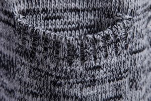 Detail of marl knit fabric and ribbed edge stitching on men's hooded cardigan sweater