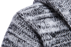 Close-up of shoulder seam detail on a heavy-knit hooded cardigan in gray marl