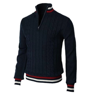 Detail of cable-knit texture and red-white striped cuffs on navy blue quarter-zip sweater