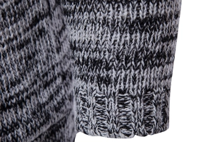 Close-up of knit sweater cuff featuring mixed grey textured fabric and ribbed edges