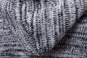 Close-up of thick mixed gray knit fabric texture and hooded neckline on a men cardigan