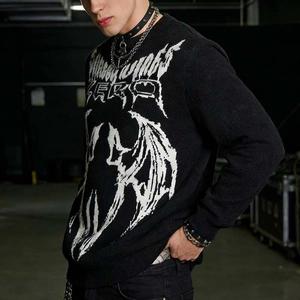 Close-up of black knitted sweater with white gothic bat wing jacquard pattern