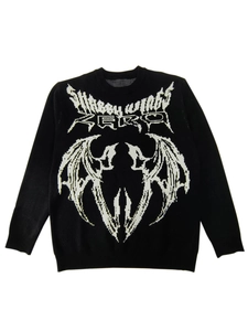 Close-up of Shaggy Wings knit sweater featuring white demon wing pattern on black fabric