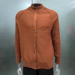 Detail of caramel men cardigan sweater with ripple knit texture and metal buttons