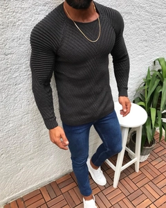 Detail showing diamond knit texture and ribbed striped sleeves on men's slim fit sweater