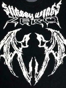 Detailed close-up of ribbed crewneck and Shabby Wings gothic graphic knit pattern