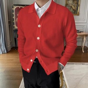 Men's casual red knit cardigan with lapel collar and buttons in a stylish indoor setting