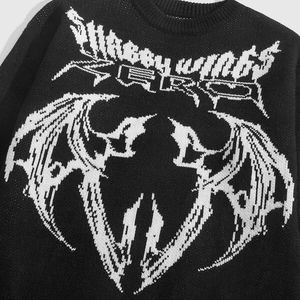 Close-up of knit texture and Shabby Wings jacquard pattern on black crewneck sweater