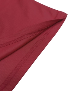 Close-up of red breathable mesh fabric with high-quality double-needle flatlock stitching