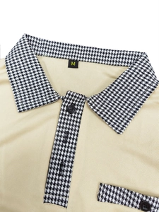 Close-up of polo shirt collar with houndstooth trim and knit cotton texture detail