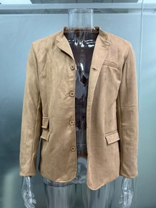 Detail view of camel suede blazer with four buttons and classic flap pockets