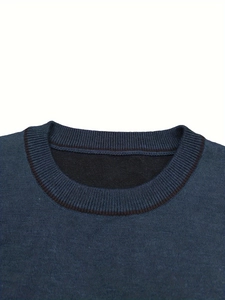 Detail showing the ribbed round neckline of a dark blue knitted men's pullover sweater