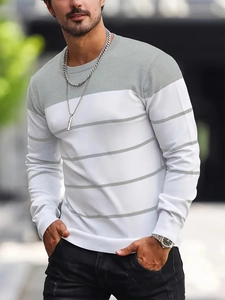 Detail of grey and white striped crew neck sweater with elastic ribbed cuffs and knit texture
