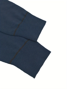 Detailed macro view of navy knit sweater cuffs with brown stripes and ribbed texture