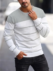 Detailed view of striped knit sweater texture and ribbed cuffs for men in autumn fashion