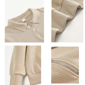 Detailed close-up of geometric diamond pattern and half-zip collar on men's sweatshirt