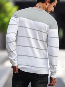 Detailed close-up showing white and grey striped knit texture on a men's round neck sweater