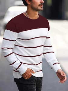 Detail of men striped color-block knit sweater showing sleeve cuff and material texture