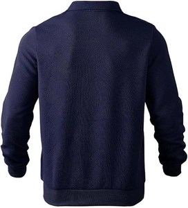 Close-up of geometric diamond weave texture and ribbed cuffs on navy blue polo sweater