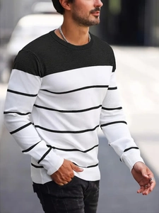 Detail of ribbed cuffs and black and white striped texture on men's knit sweater