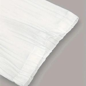 Détail du tissu à rayures blanches avec texture plissée et couture soignée sur la manche