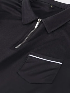 Close-up of black polo shirt featuring a metal zipper collar and chest pocket detail